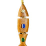 Wooden pendant with embedded gemstones on a textured surface