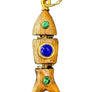 Wooden pendant with gold accents, blue gem, and green stones on a gray textured background