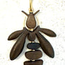 Wooden Bee Sculptural Pendant
Hand-carved wooden bee pendant with gold accents by Viviane Guenoun sculptural statement jewelry