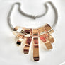 Gold bow-shaped necklace on a white background