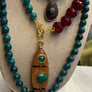 Set of beaded necklaces and earrings on a mannequin bust.