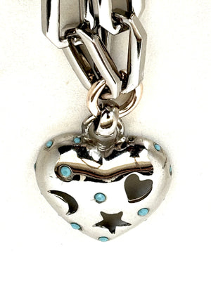 	•	Silver color plated brass chain (60cm)
	•	Heart pendant with celestial cutouts (moon, star, heart)
	•	Turquoise details for a unique, trendy look
	•	Stylish and versatile – wear alone or mix & match with other necklaces