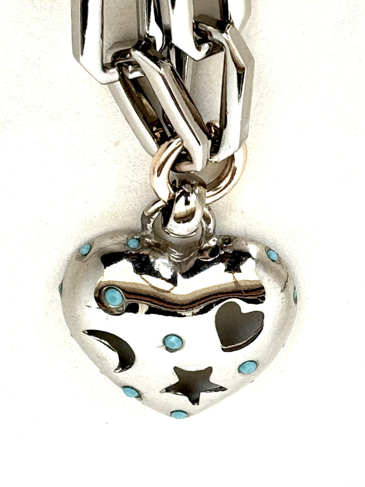 	•	Silver color plated brass chain (60cm)
	•	Heart pendant with celestial cutouts (moon, star, heart)
	•	Turquoise details for a unique, trendy look
	•	Stylish and versatile – wear alone or mix & match with other necklaces
