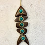 
Artisan wooden pendant with gold-plated cap and turquoise stone accents by Viviane Guenoun
