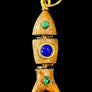 Wooden pendant with gold accents, blue gem, and green stones on a gray textured background