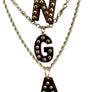 Necklace with wooden letter pendants 'N', 'G', and 'A' on a gray stand.